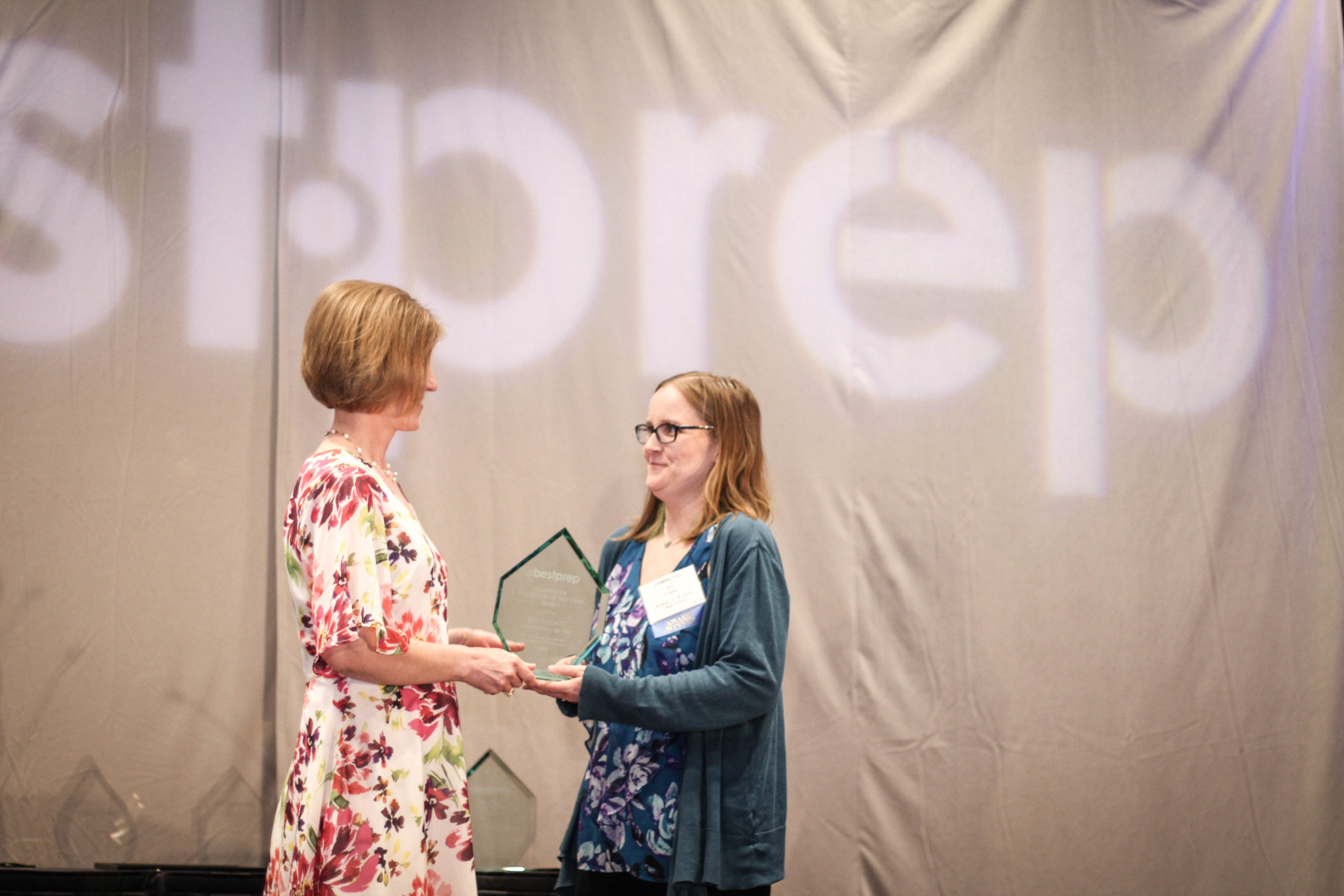 woman receiving award on stage