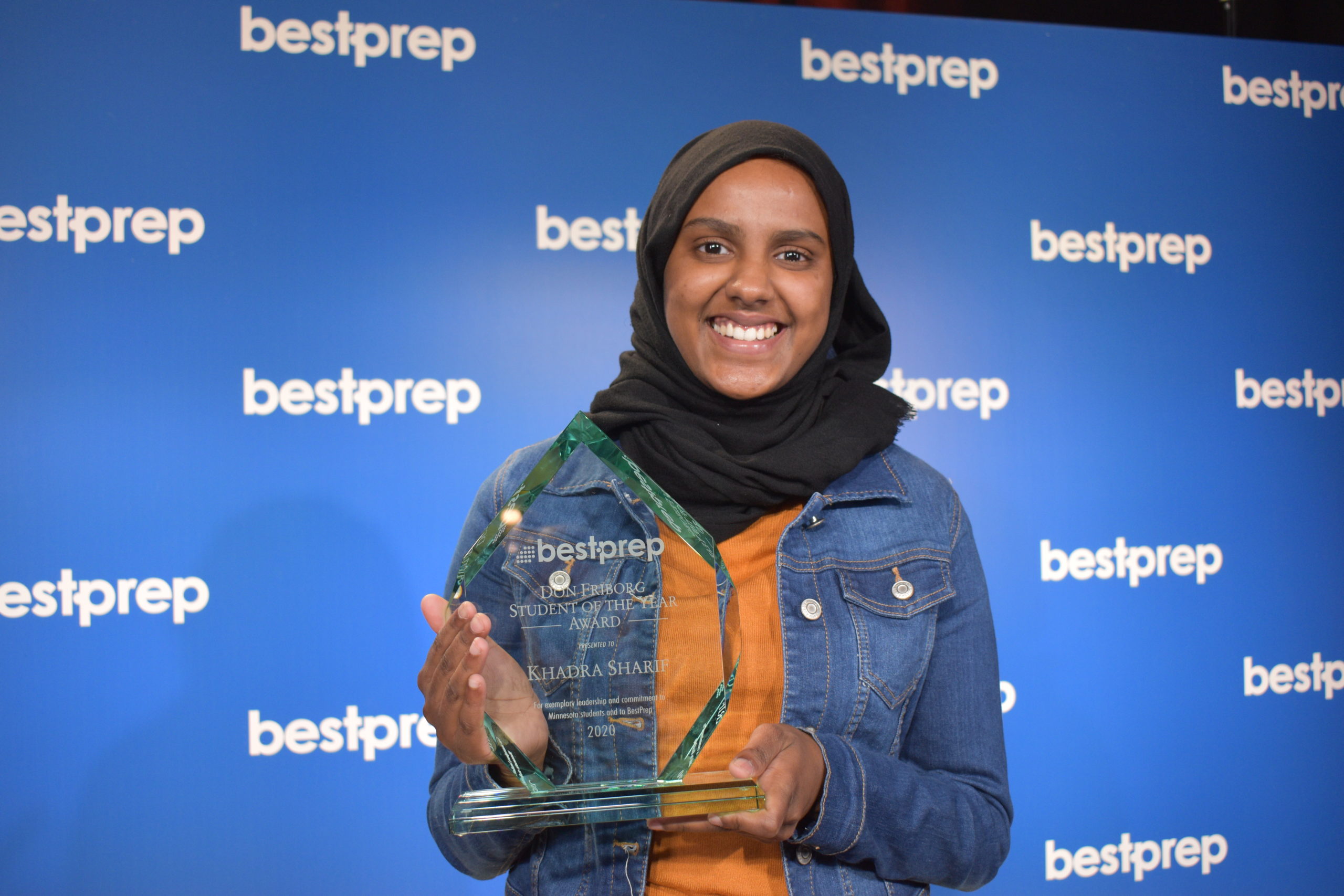 khadra sharif holding award at bestprep annual luncheon