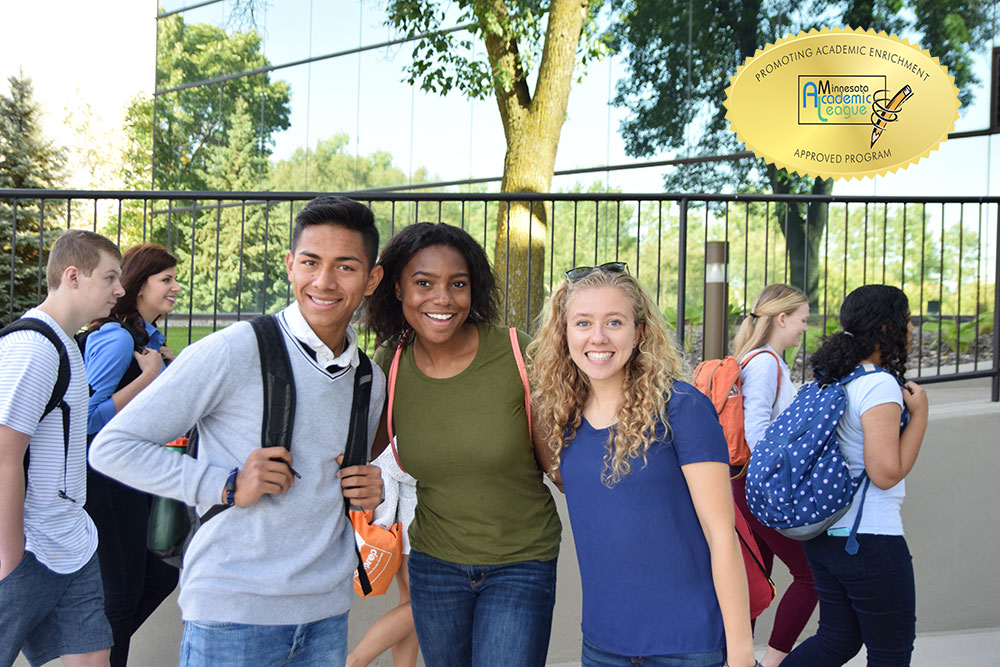 about, with alc seal students in front of school with backpacks