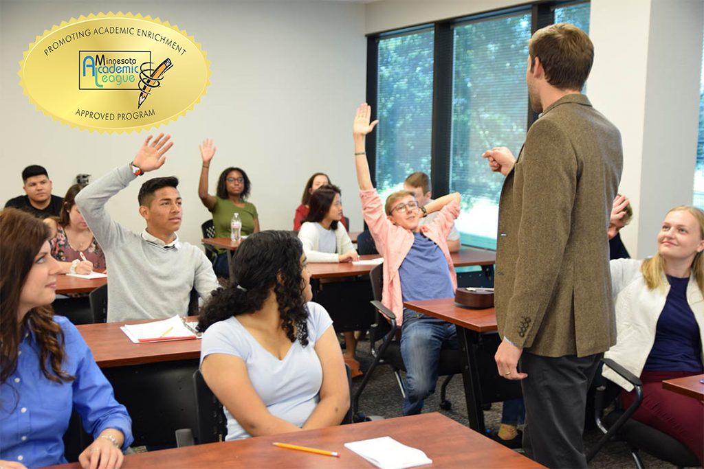 no background educators-1024x683 teacher pointing at students with hands raised