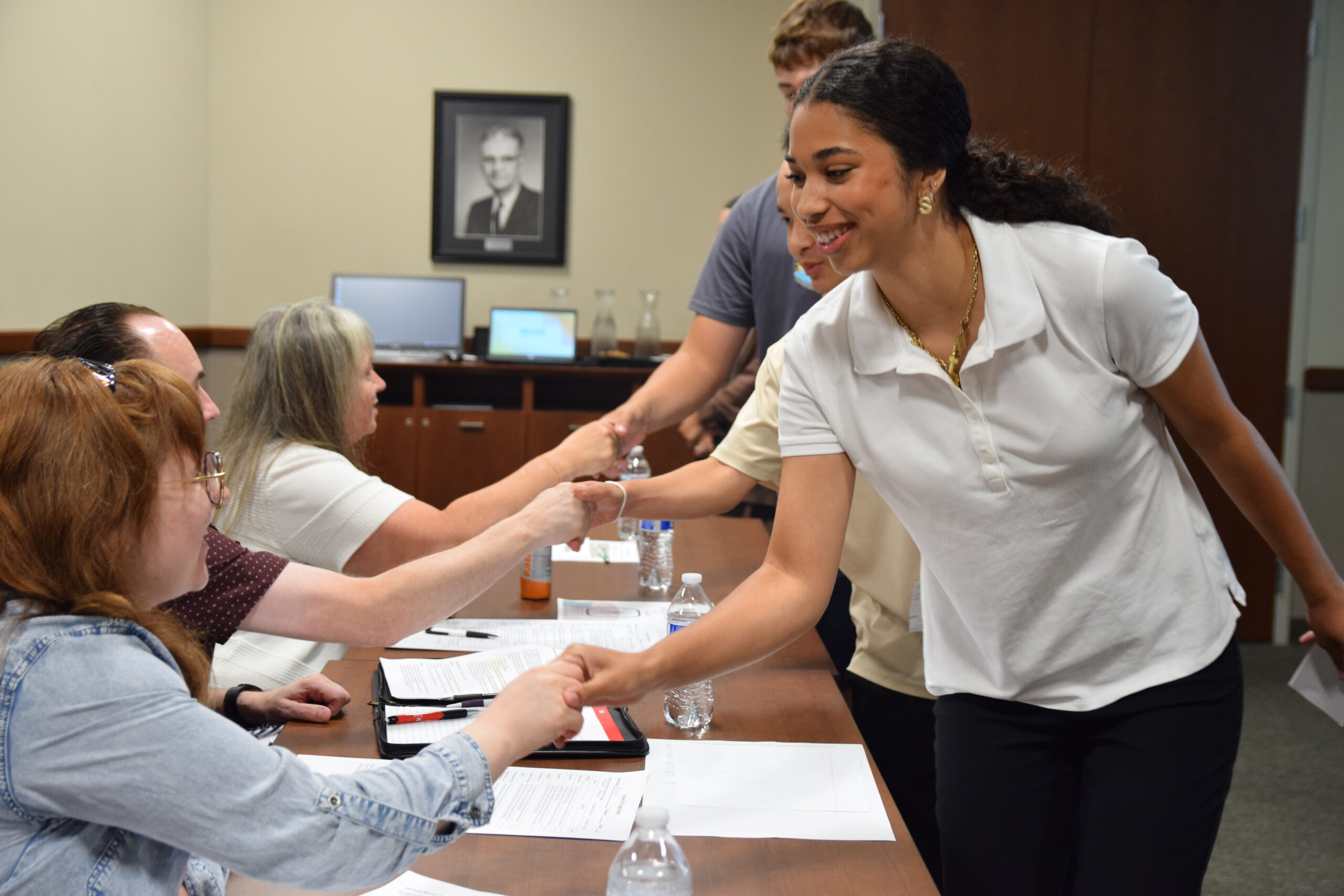 Students shaking volunteer's hands